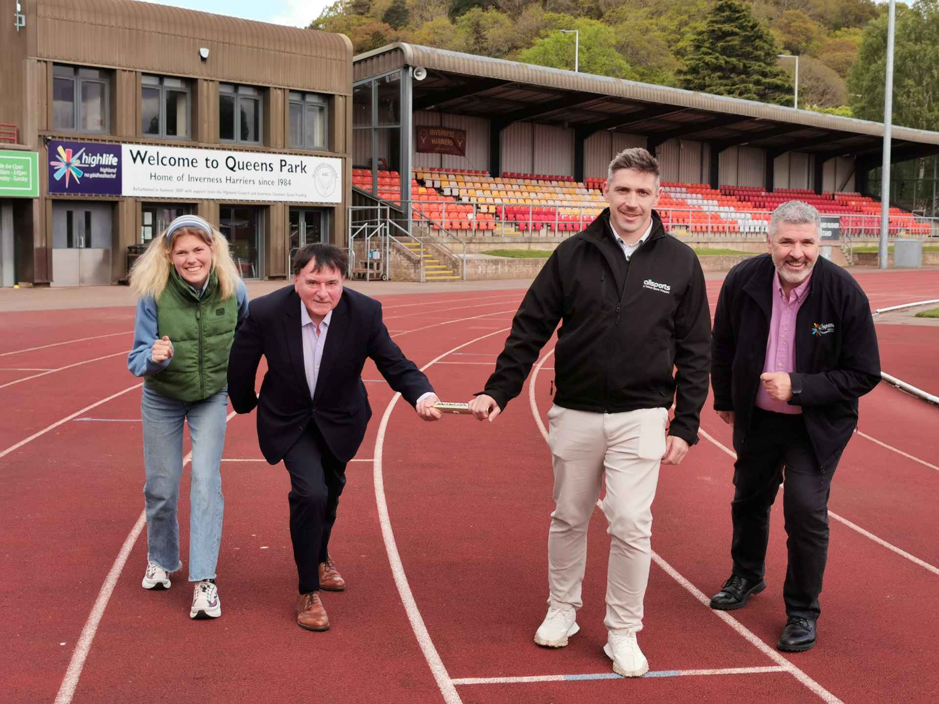 Cllr Ken Gowans passes the baton to Craig Robertson, Allsports Construction & Maintenance to mark the symbolic handover of Queens Park running track
